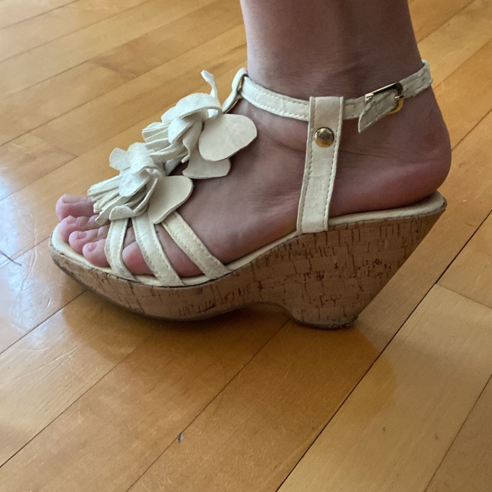 Cork wedges with cream colored straps and flower petal pattern